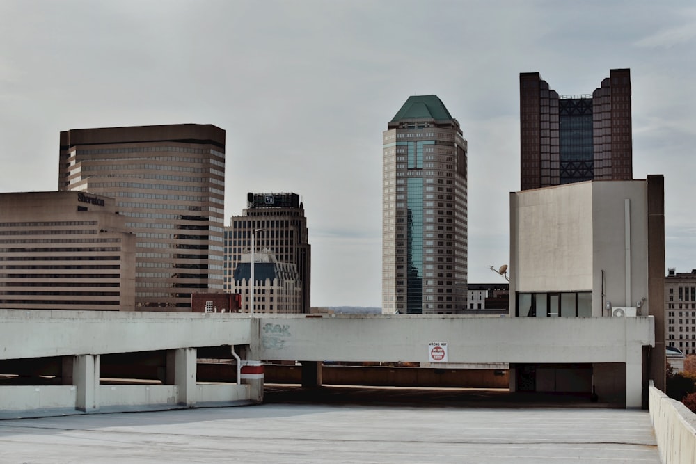 a city skyline with tall buildings and a bridge