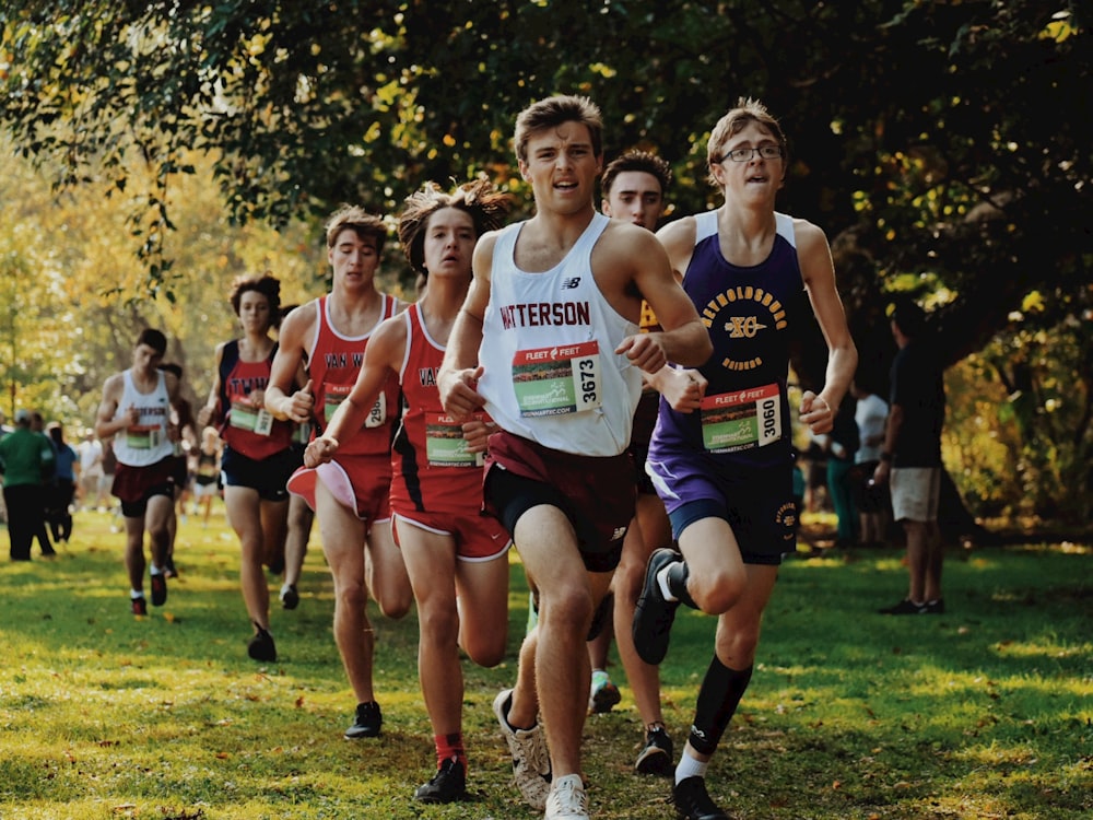 a group of young men running in a race