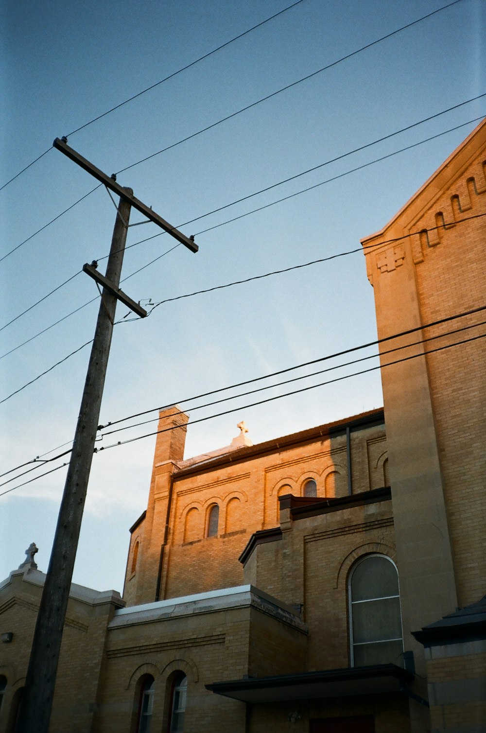an old church with a telephone pole in front of it