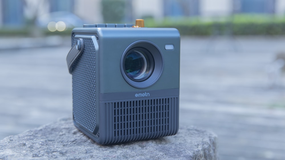 a small camera sitting on top of a rock