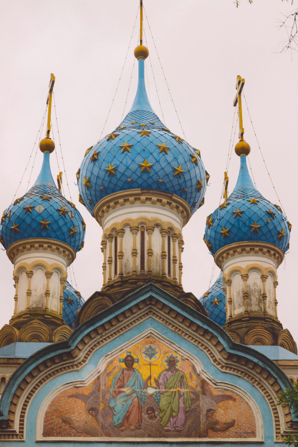 a blue and white building with a clock on it's side