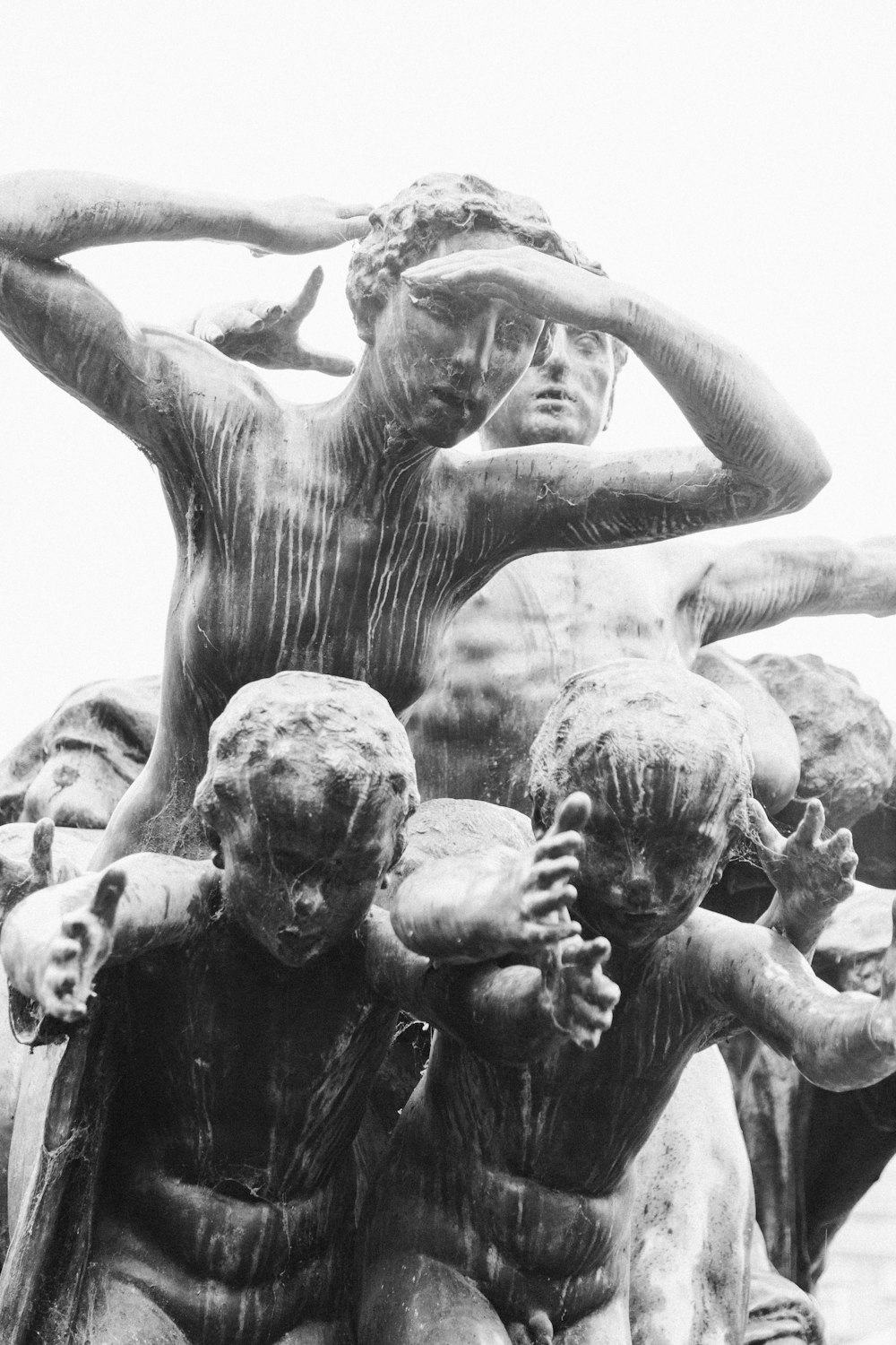 a black and white photo of a group of statues