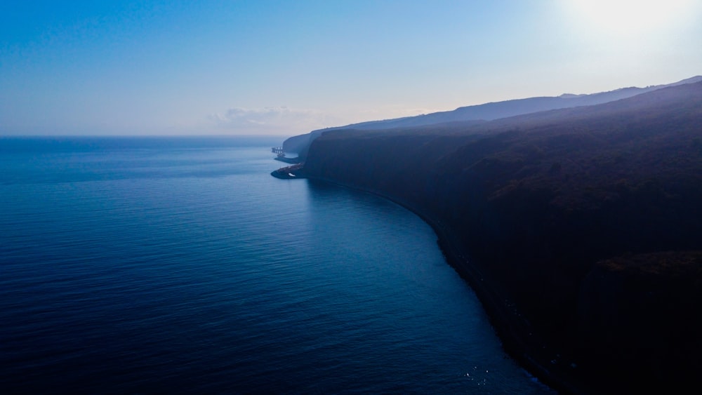 a large body of water near a cliff