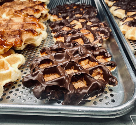 a close up of waffles and other pastries on a tray