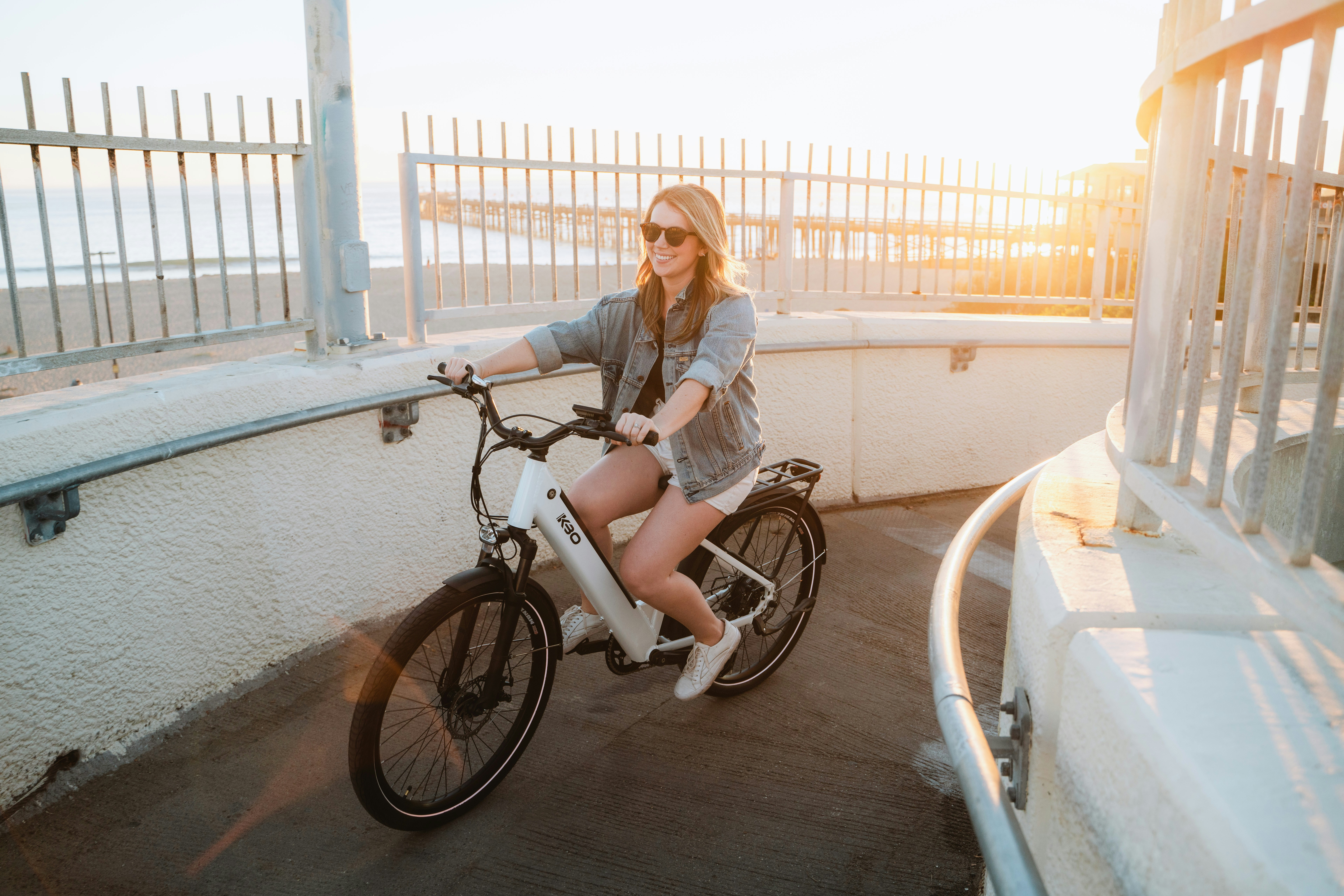 a woman riding a bike on a bridge