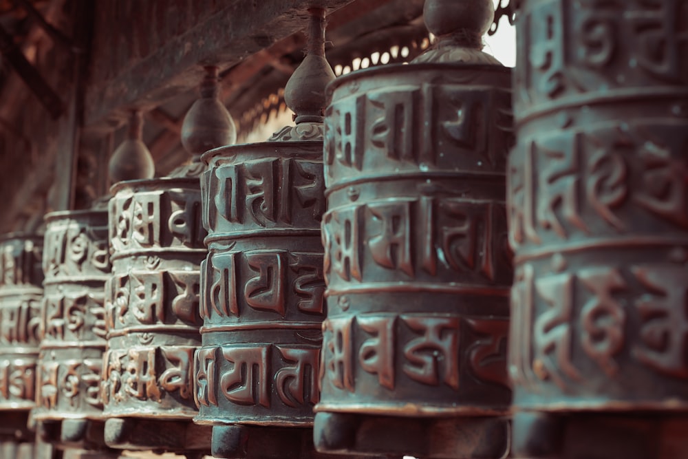 a group of bells hanging from the side of a building