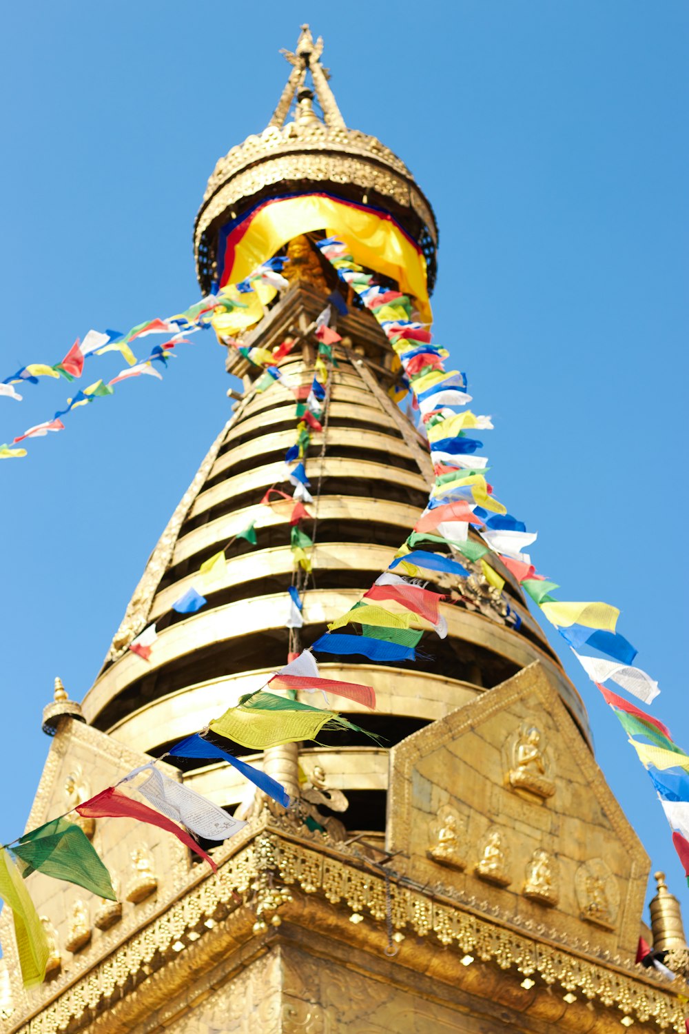 a very tall tower with a lot of flags on it