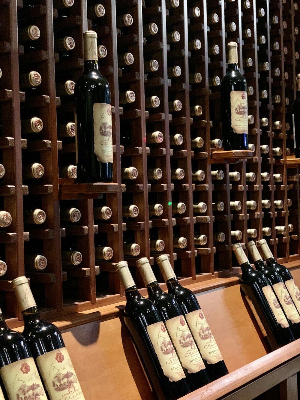 several bottles of wine are lined up on a shelf