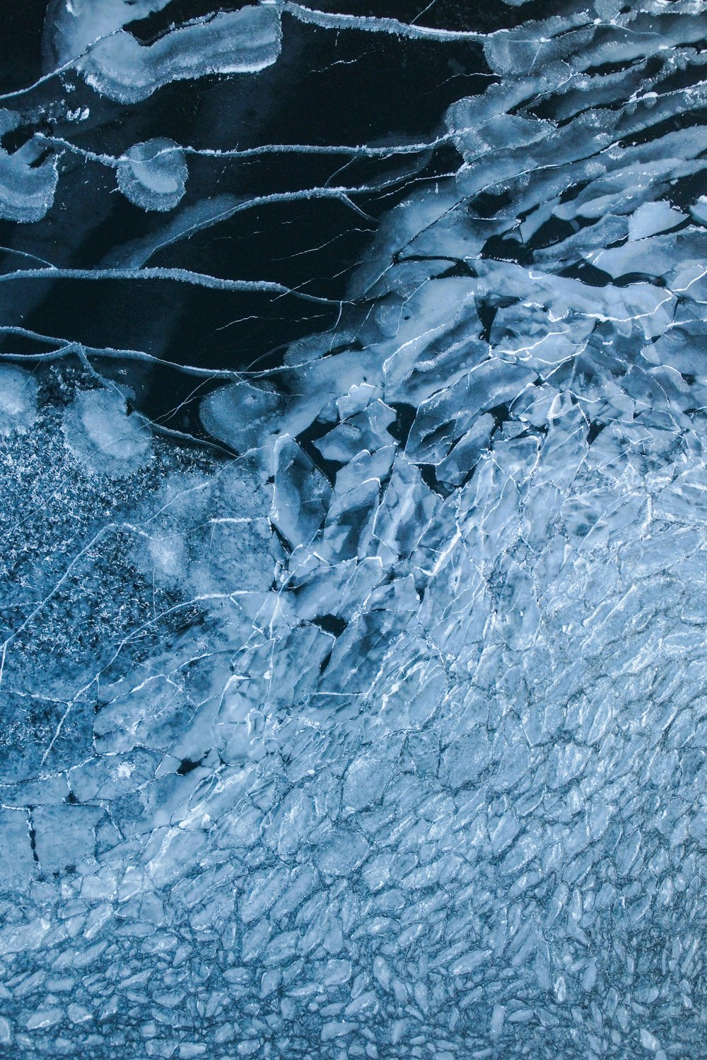 a large amount of ice floating on top of a body of water