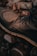 A rugged brown leather boot with lace-up details rests on a surface of wet, smooth stones. The setting suggests an outdoor environment, evoking a sense of adventure or exploration.