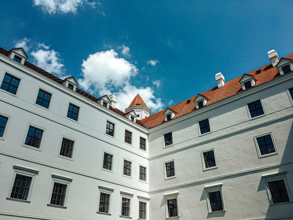 a large white building with a clock on the top of it