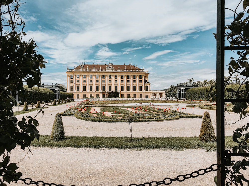 a large building with a garden in front of it