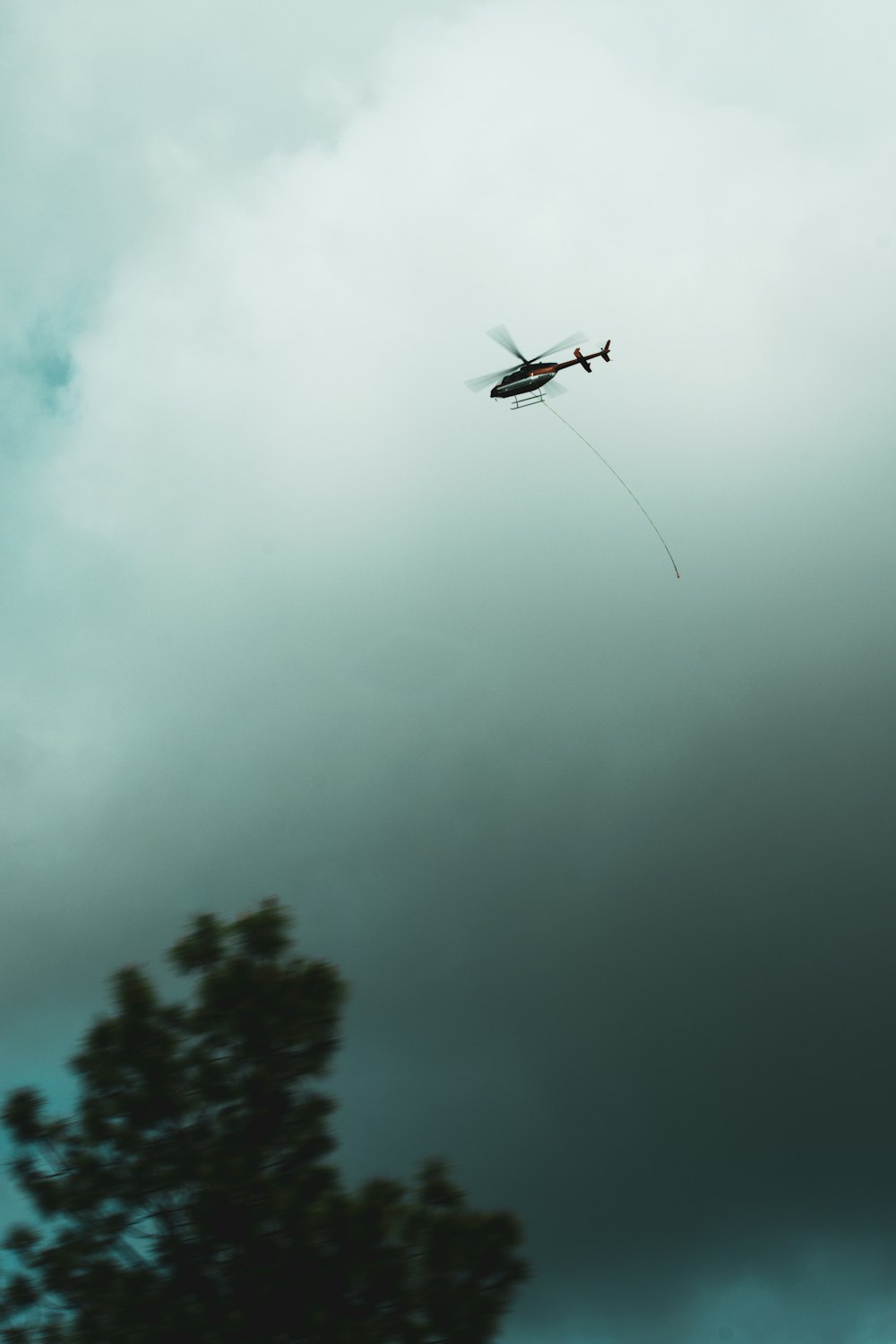 a small plane flying through a cloudy sky