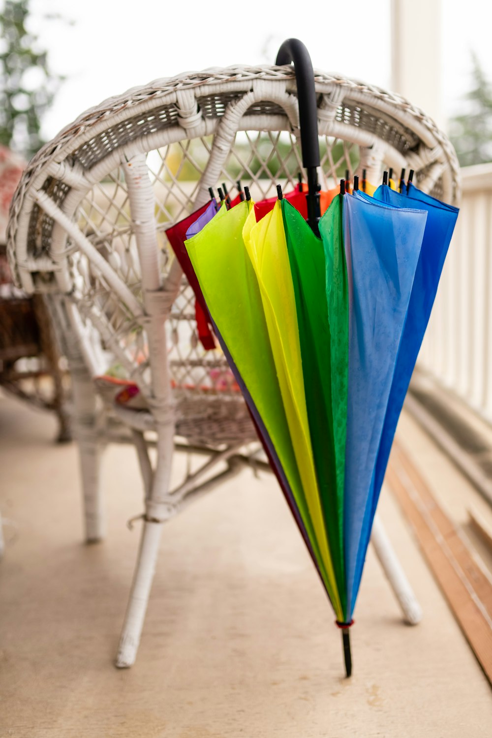 a multicolored umbrella hanging from a white chair