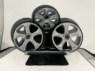 Set of three different car wheels displayed on a clean white background.