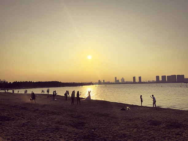 Couple taking photos during a sunset tour along Rio de Janeiro's coastline.
