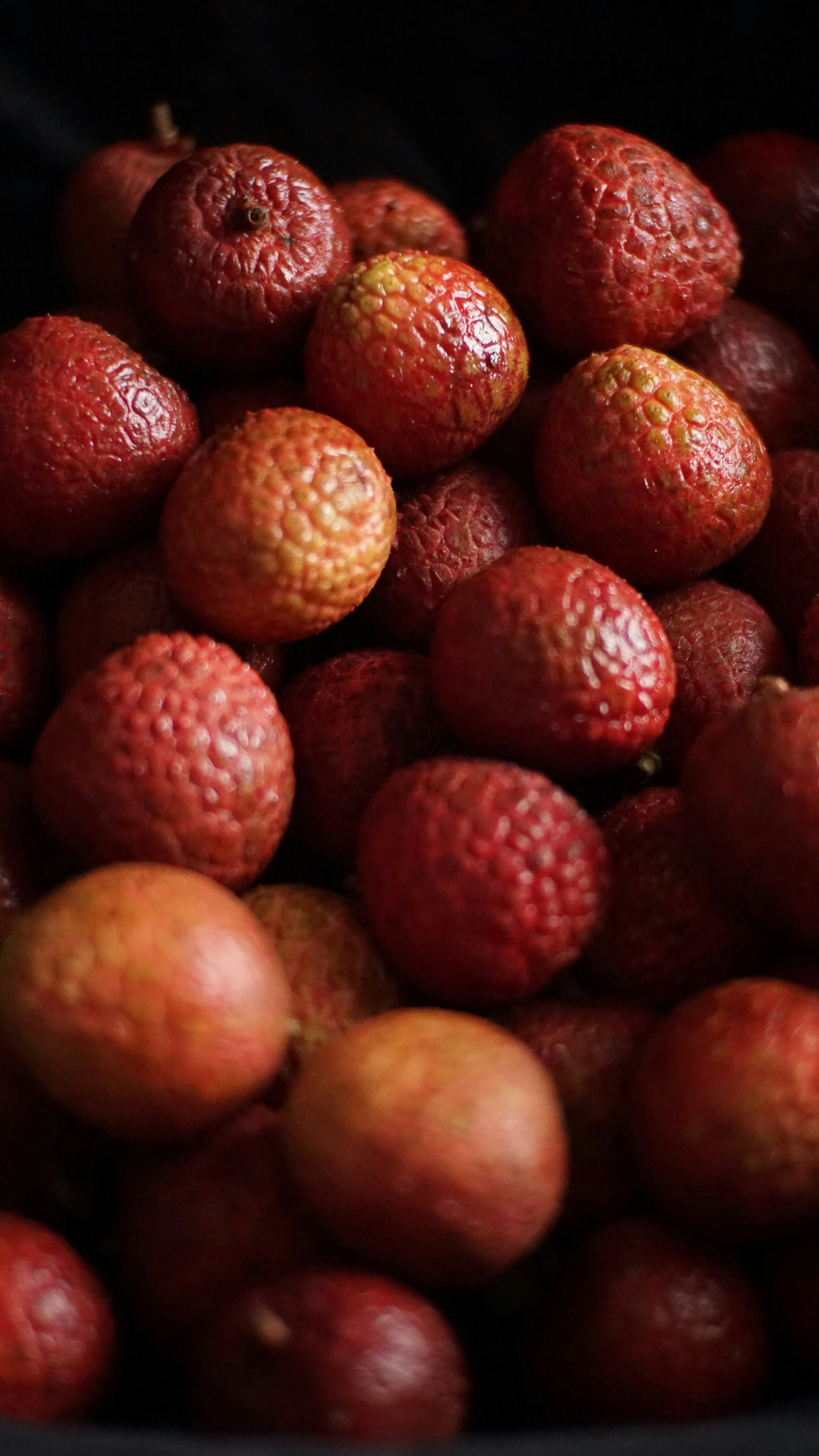a pile of red fruit sitting on top of a table