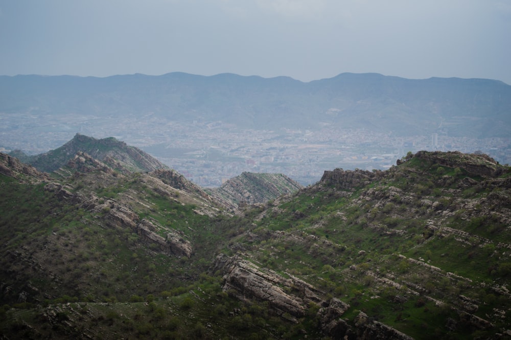 a view of a valley with mountains in the background