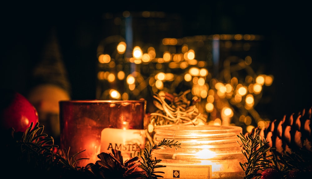 a candle and some pine cones on a table