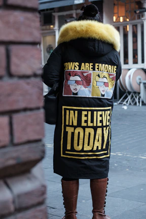 a person wearing a jacket with a slogan on it