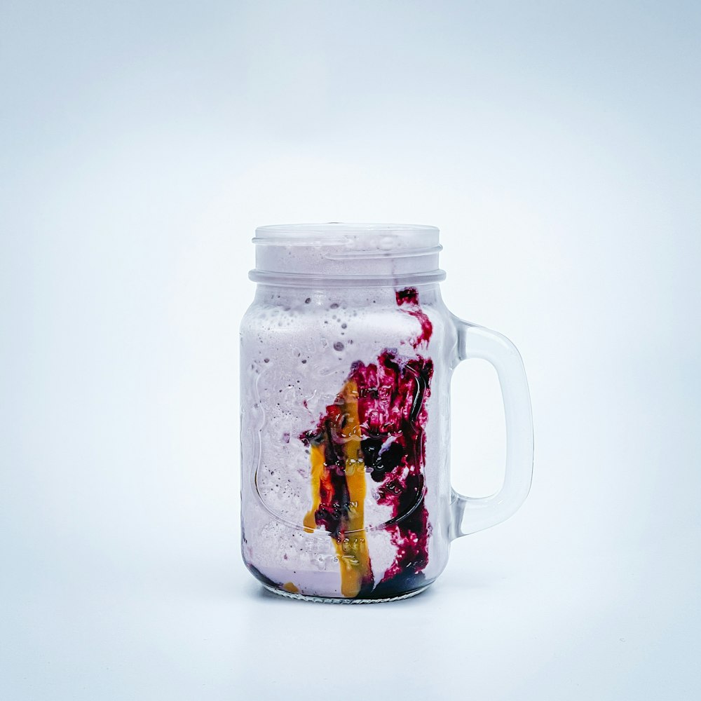 a glass jar with a painting on it
