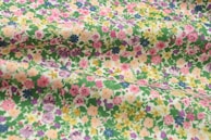 A selection of printed fabrics featuring floral designs.