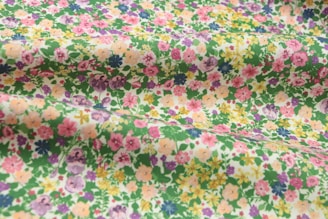 A selection of printed fabrics featuring floral designs.