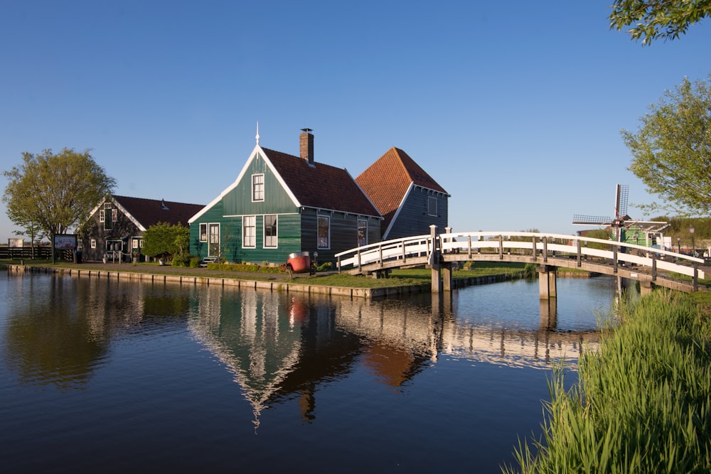 a bridge over a body of water next to a house