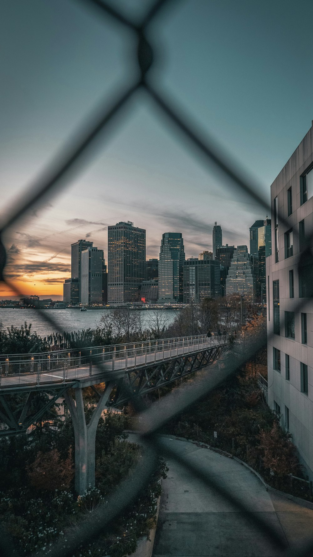 a view of a city through a fence