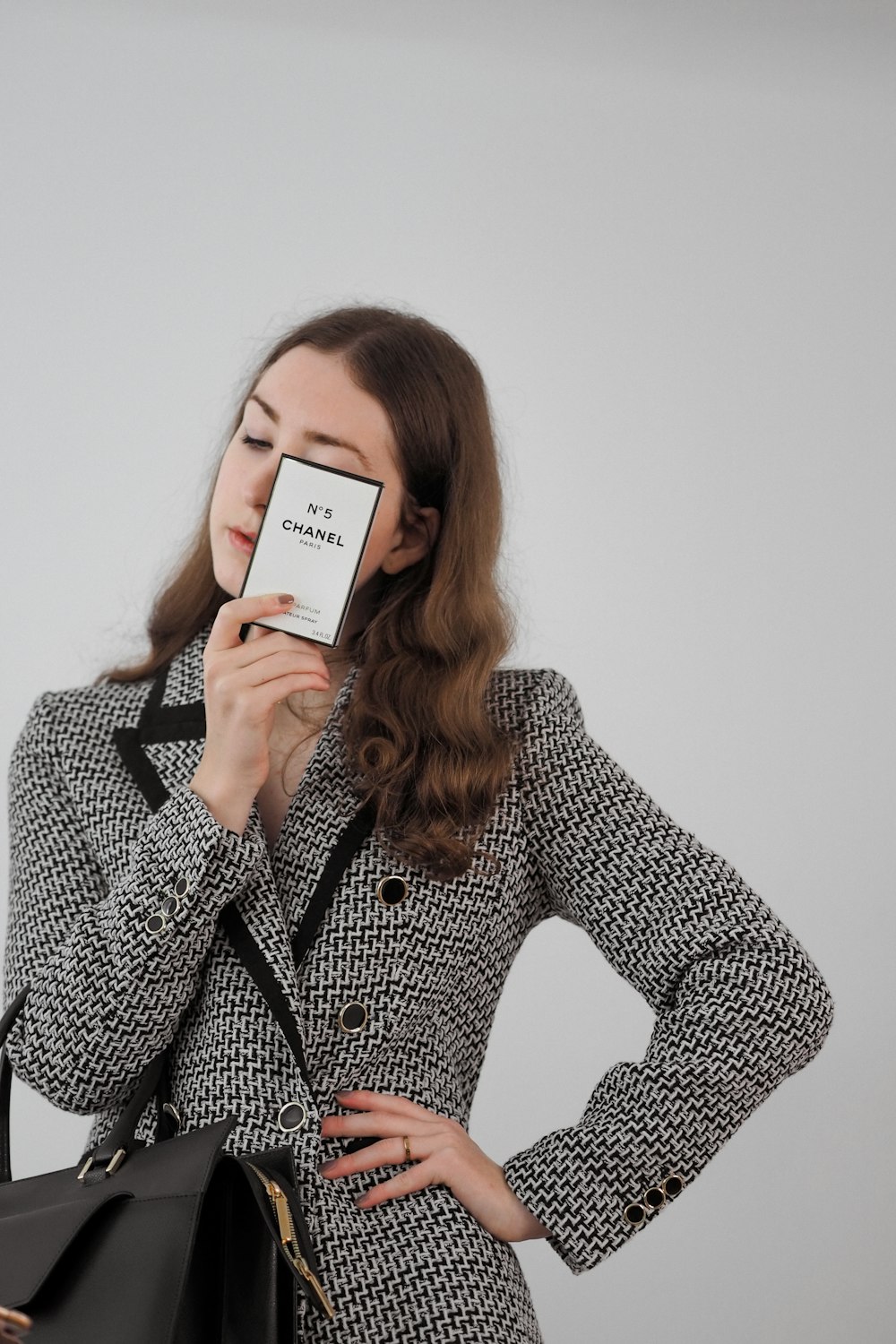 a woman holding a business card up to her face