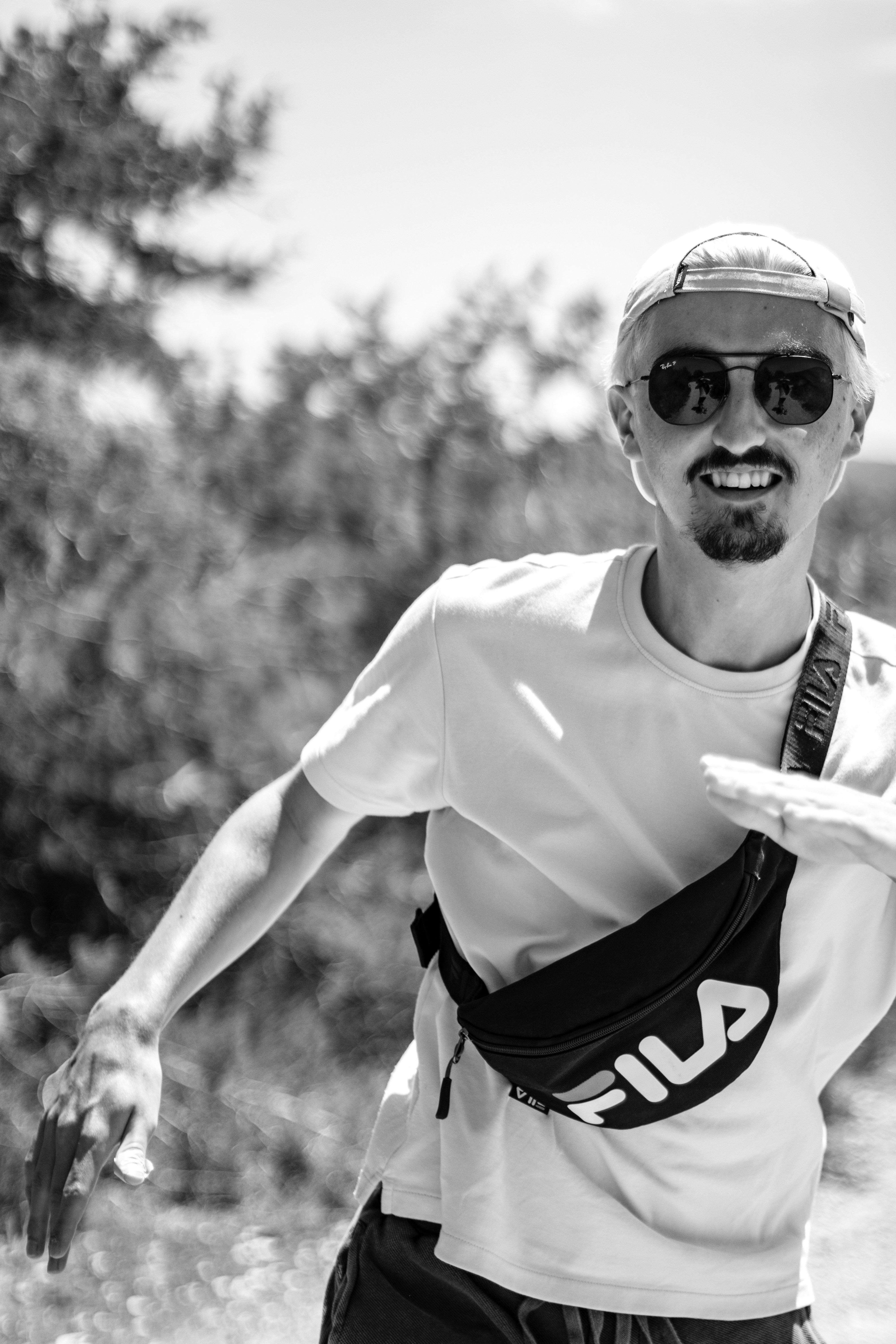 Portrait of Marcus Chen, adventure traveler, smiling outdoors