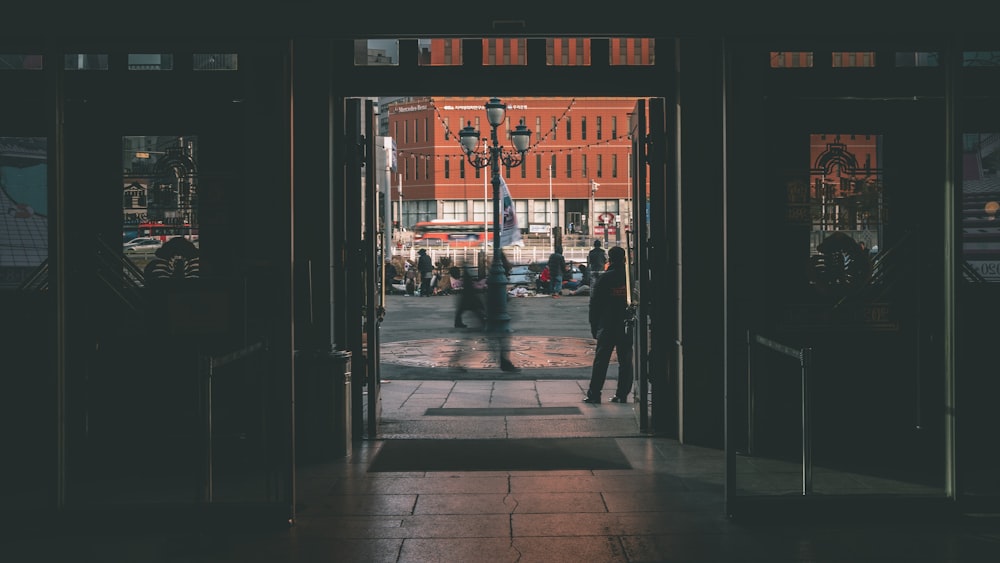 a couple of people that are standing outside of a building