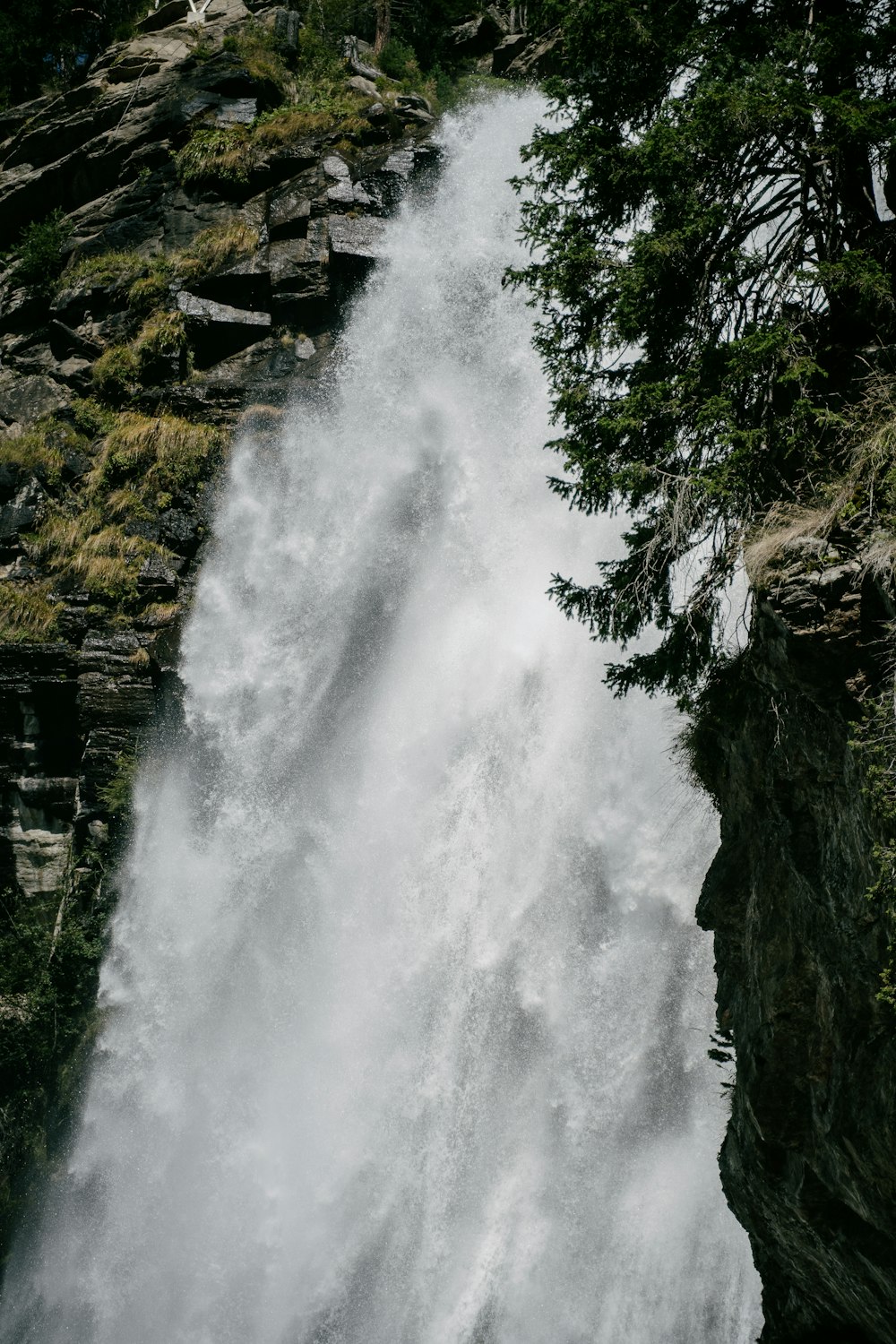 a man riding a surfboard on top of a waterfall