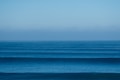 a large body of water sitting under a blue sky