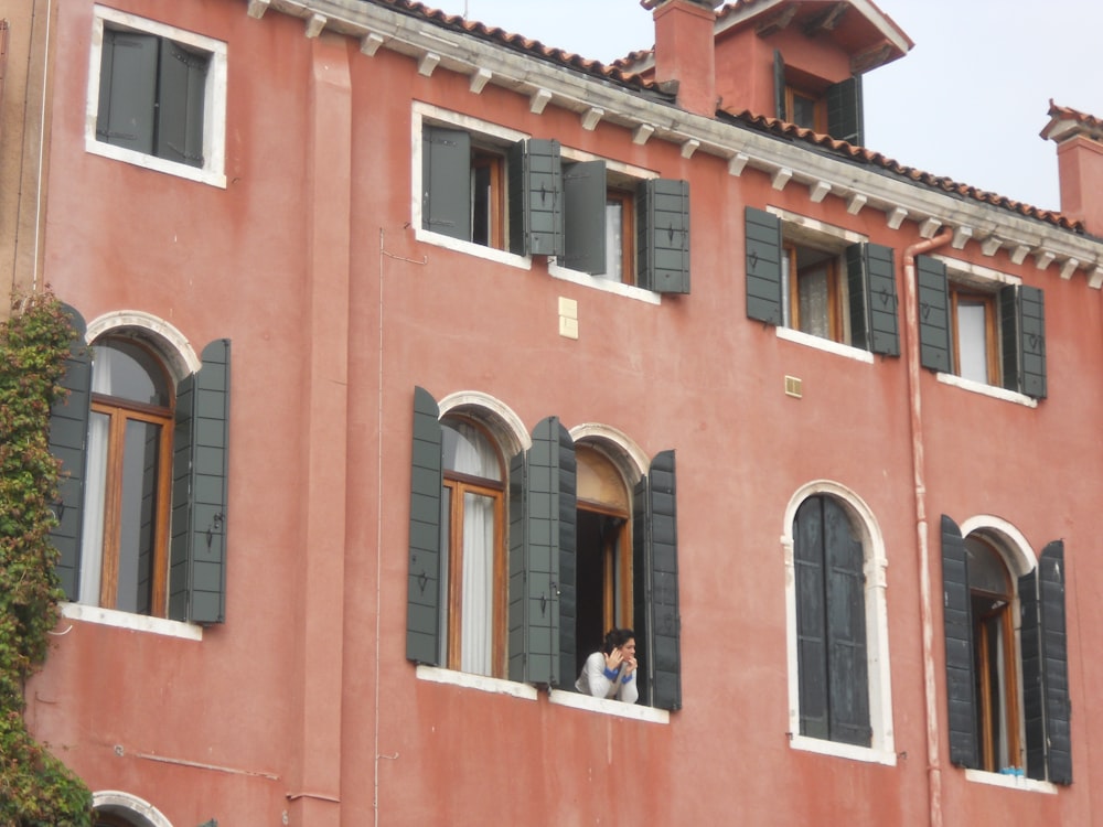 a couple of people that are looking out of a window