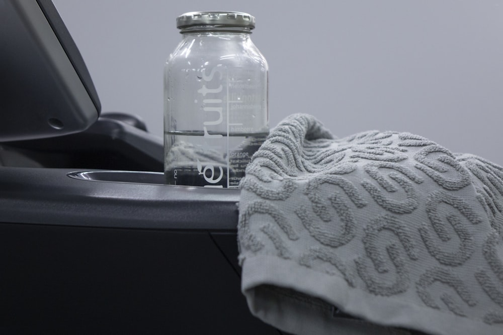 a bottle of water sitting next to a towel