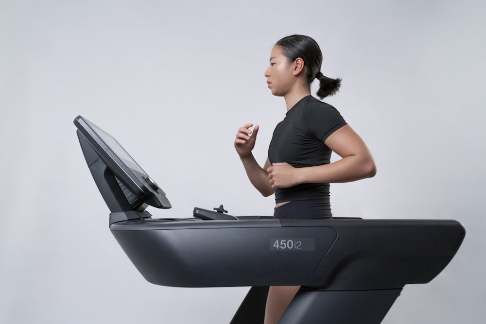 a woman is running on a treadmill