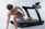 Man running on a treadmill with sleek gym machines in the background