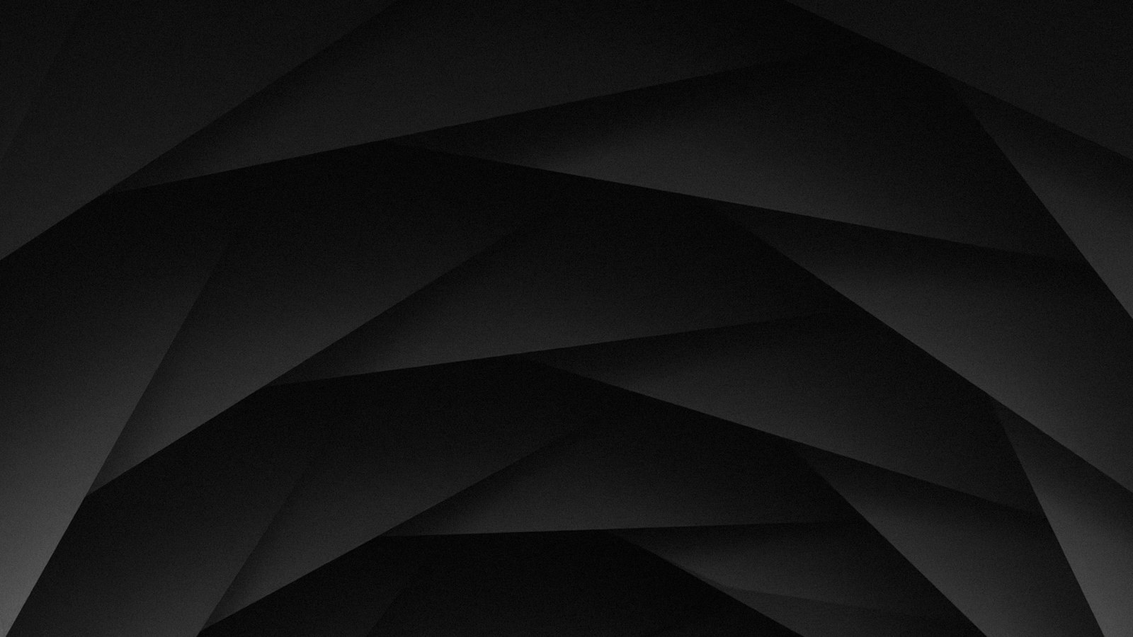 Overlapping dark grey geometric shapes creating a layered abstract pattern