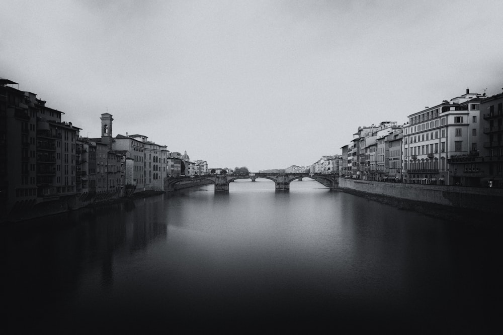 a black and white photo of a bridge over a river