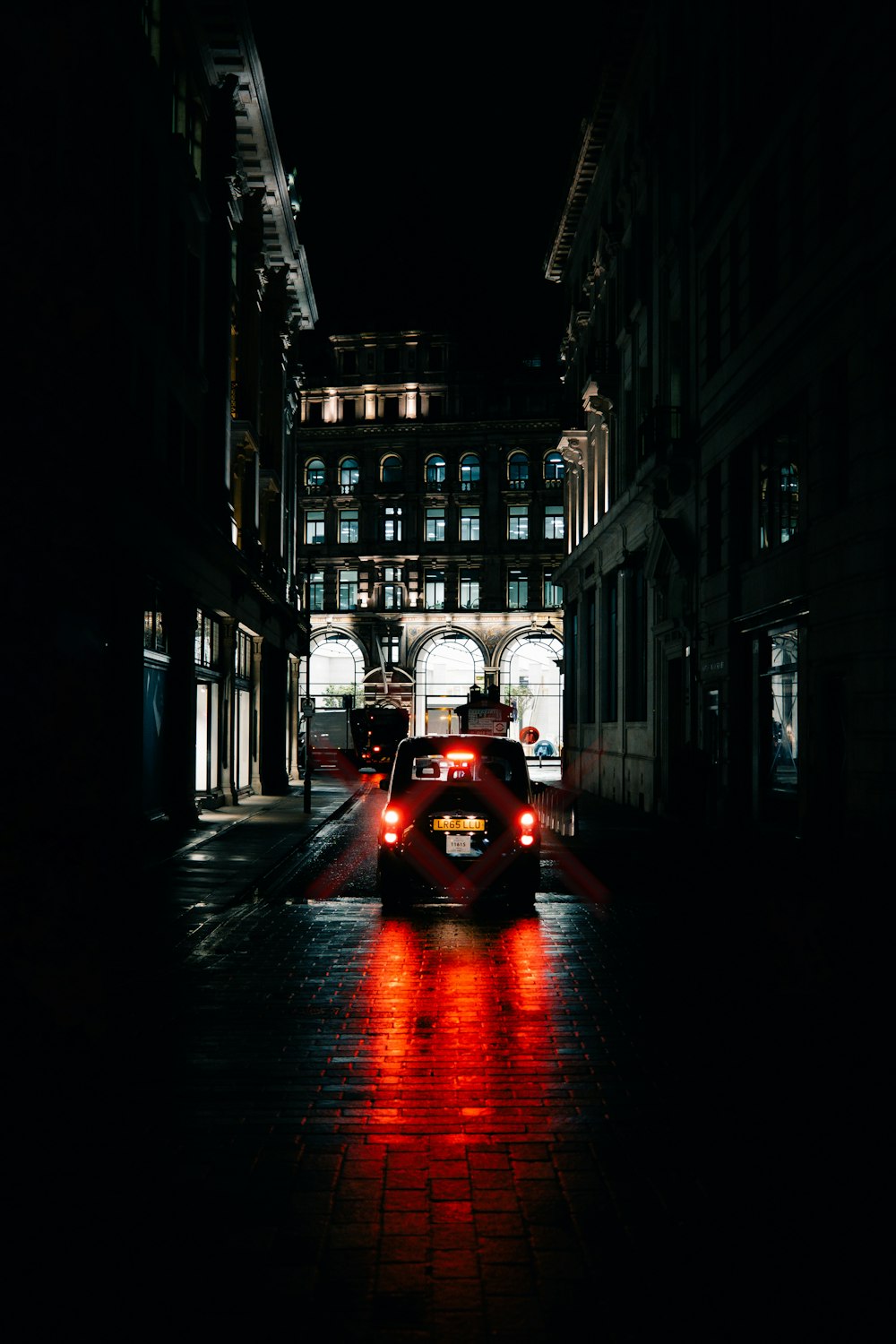 a car driving down a street at night