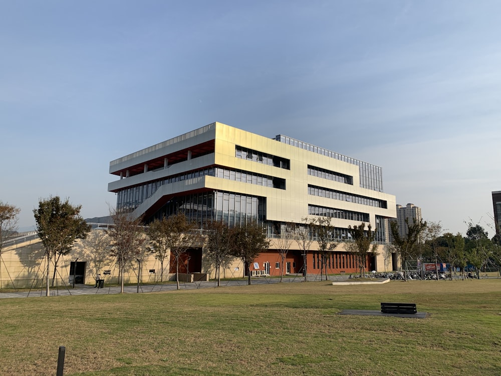 a large building with a grassy field in front of it