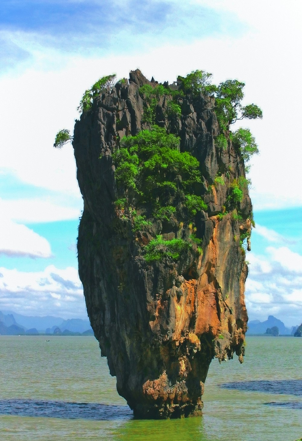 a large rock sticking out of the water