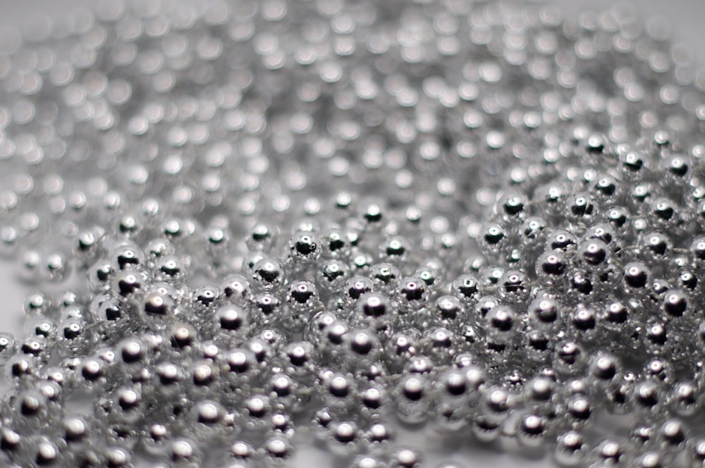 a bunch of silver balls sitting on top of a table