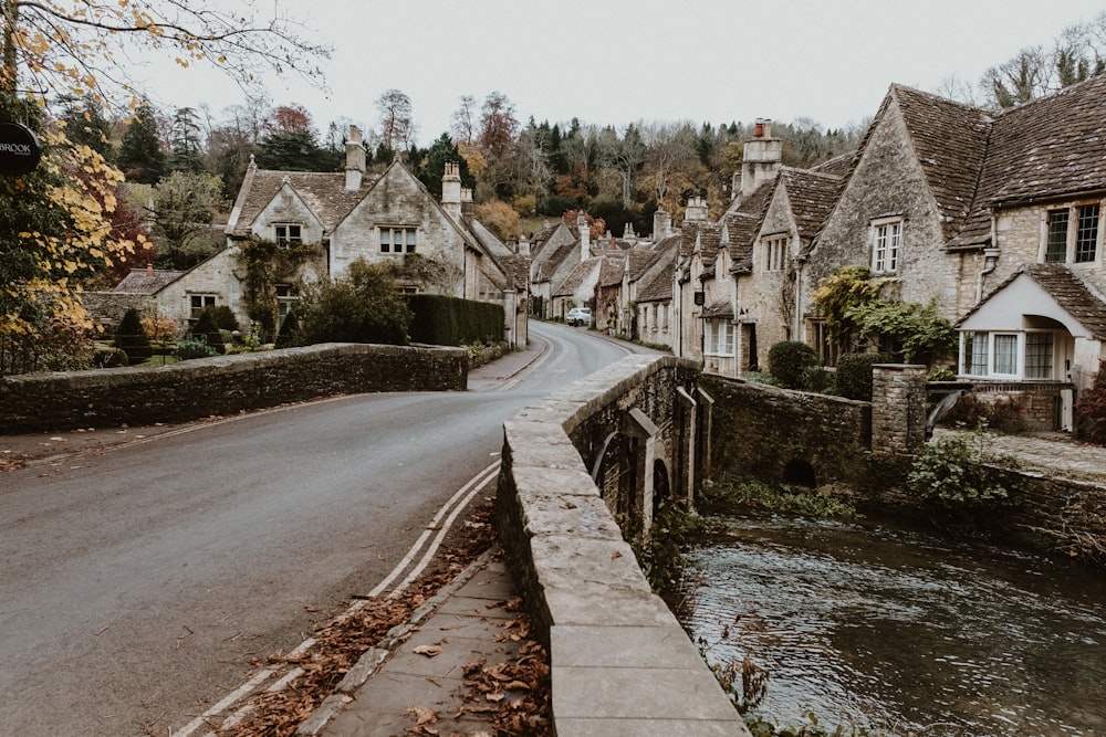 a street lined with houses next to a river