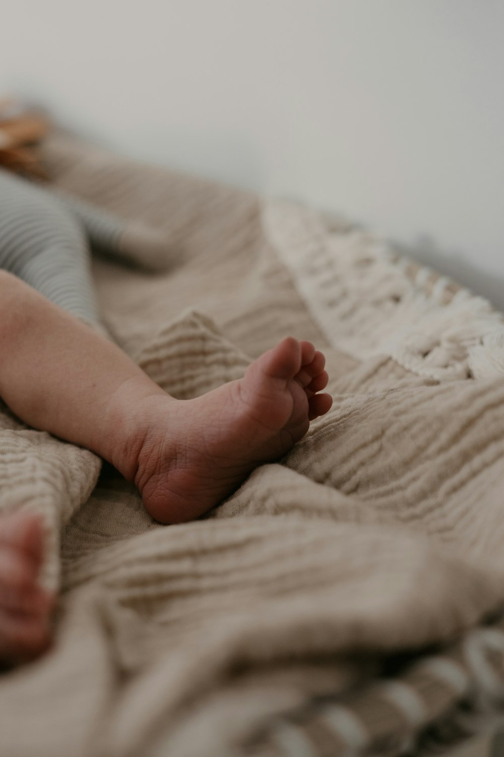 a baby laying on top of a blanket on top of a bed