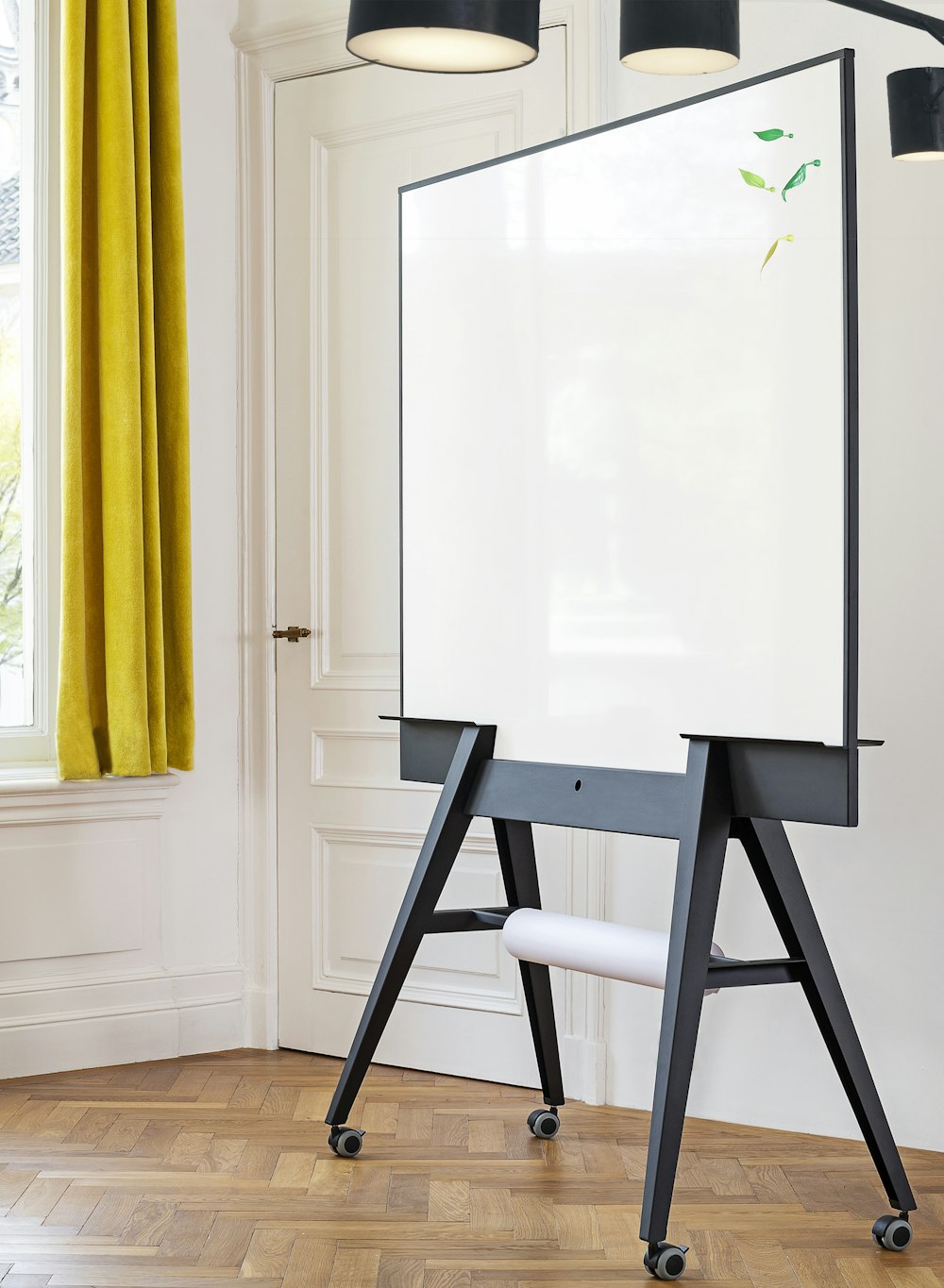 a white board sitting on top of a wooden floor
