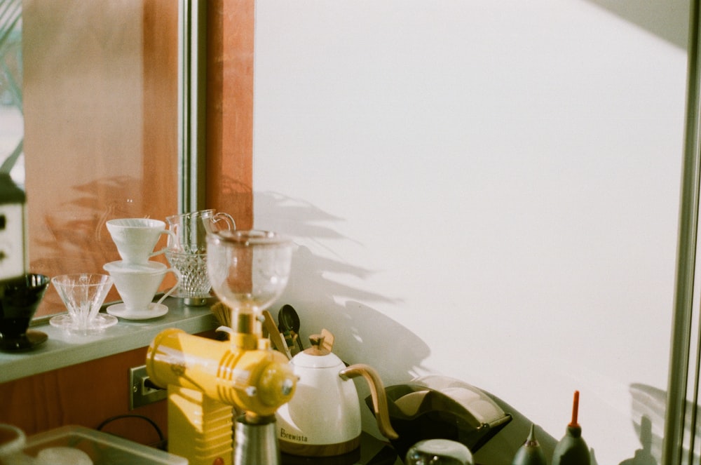 a kitchen counter topped with lots of clutter