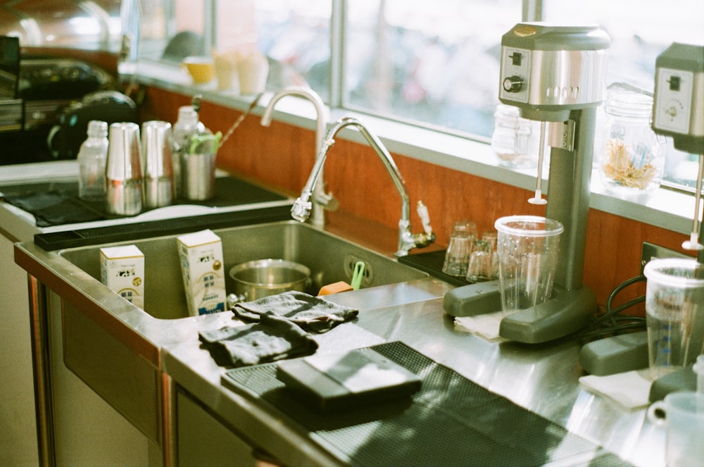 a kitchen counter with a sink and a blender