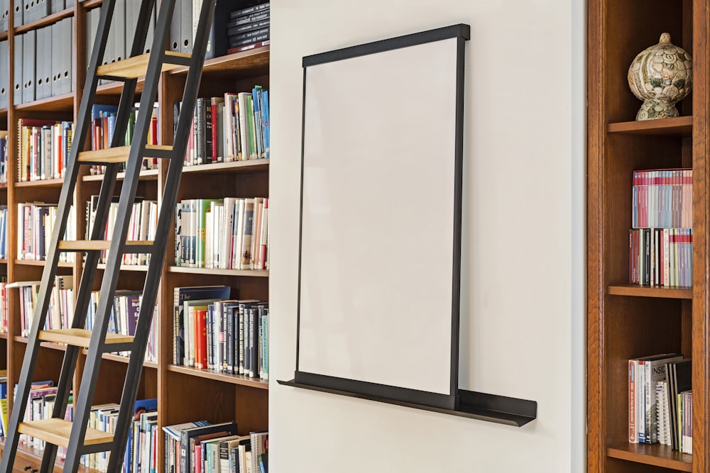 a bookshelf full of books with a ladder next to it